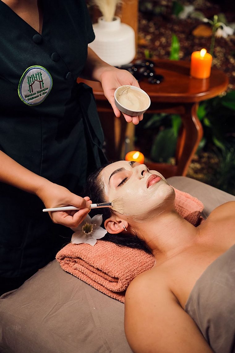 Guest receiving a facial treatment with a face mask