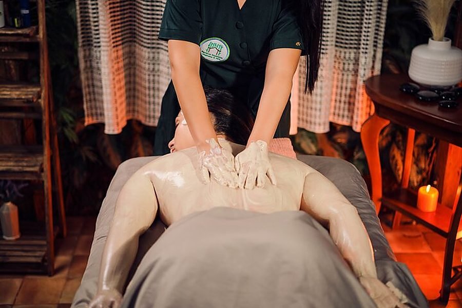 Therapist applying a body wrap during a massage
